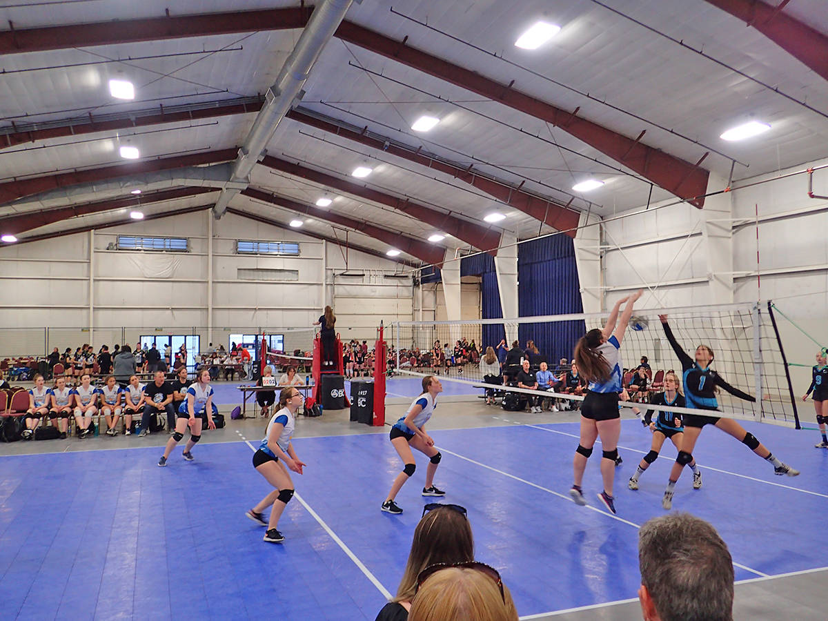 People playing volleyball indoors